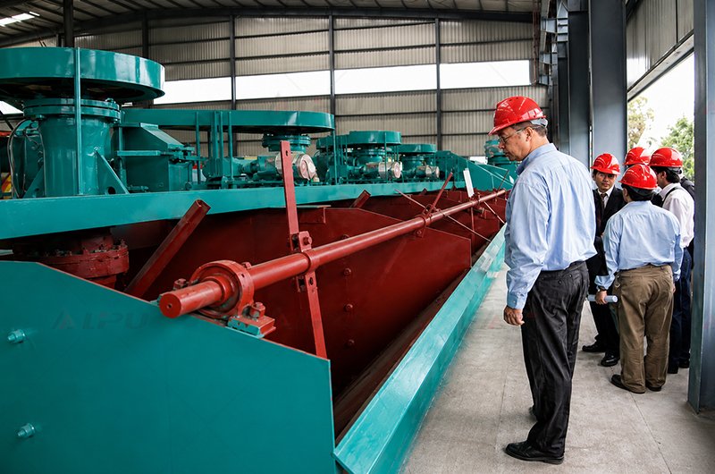 Customer flotation machine installation in a blue industrial processing plant with multiple flotation cells arranged in a production line.