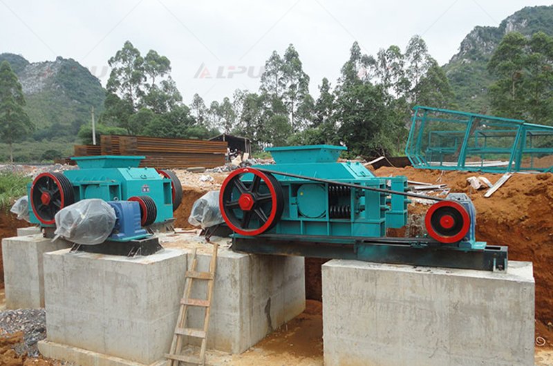 Double roll crusher installed at an outdoor mining and material processing site
