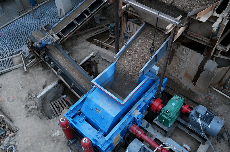 Double roll crusher processing coal gangue at an industrial material processing site