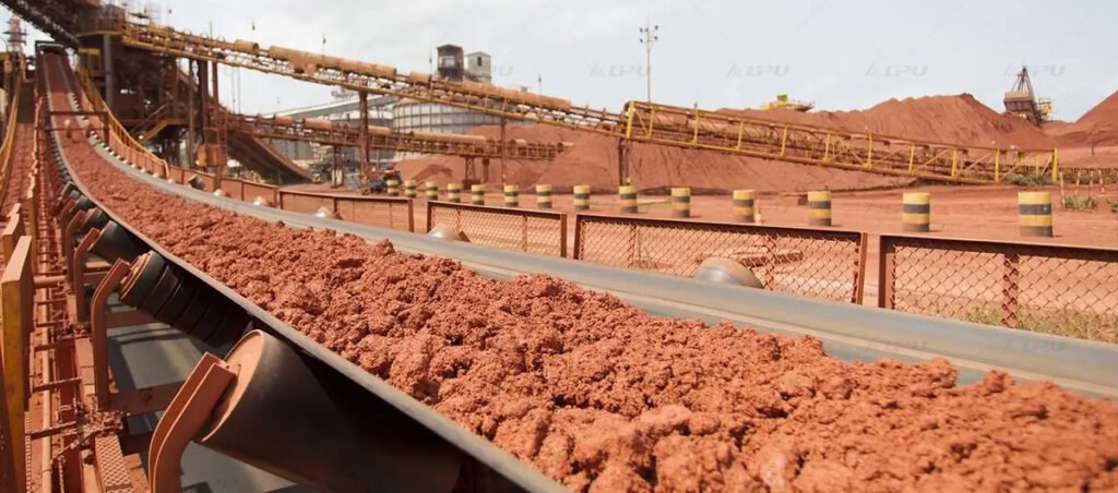 Crushed mineral material transported on a belt conveyor at a mineral processing plant.